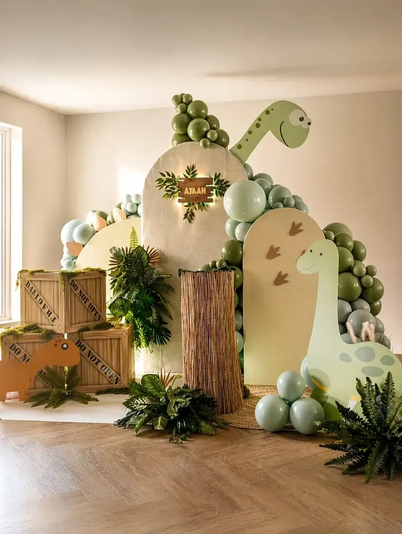 Sage green dinosaur children's birthday styling in Surrey by River Fox Events - Ayaan name sign and tropical foliage