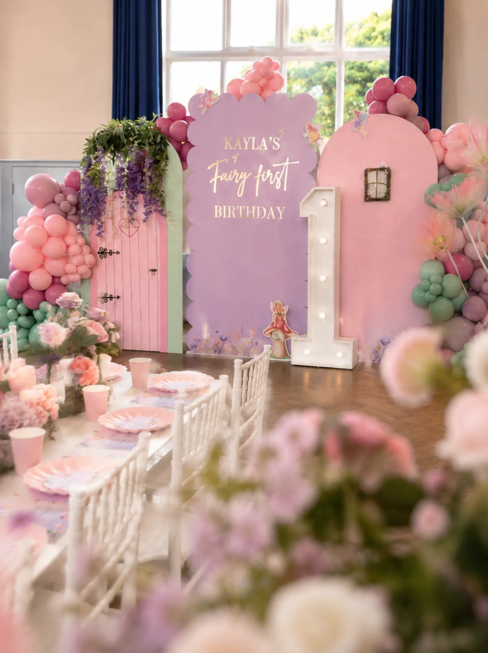 Fairy first birthday arch and light-up one marquee for Kayla in Surrey by River Fox Events - pink and lilac balloons with mossy detail
